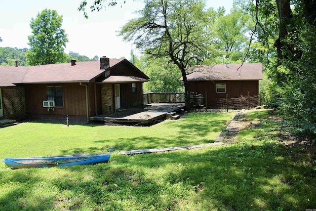 back of property featuring cooling unit, a yard, and a chimney