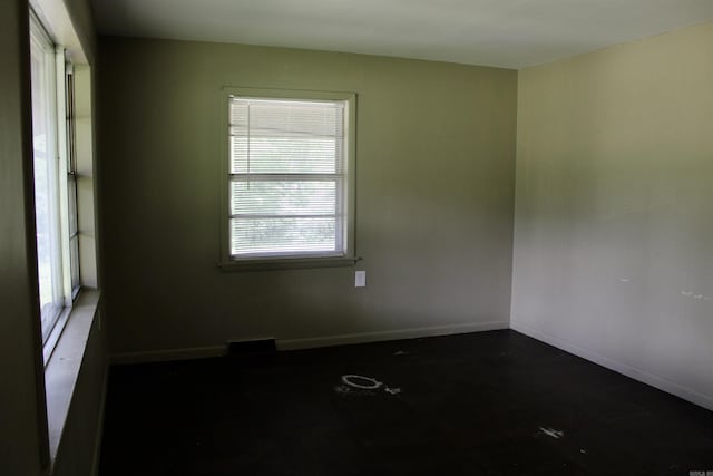 empty room with visible vents and baseboards