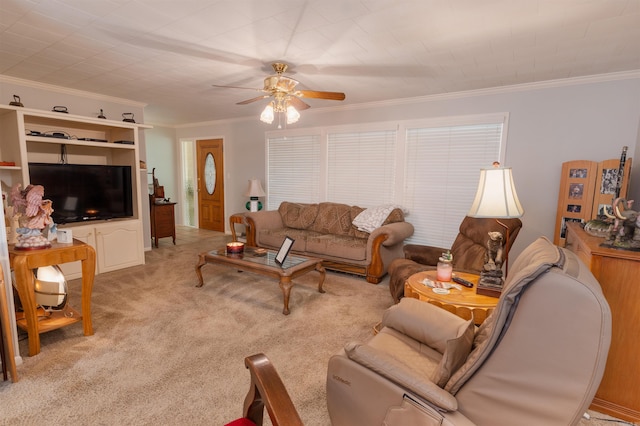 carpeted living room featuring ceiling fan and ornamental molding