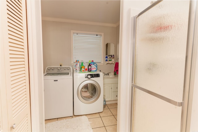 laundry room with sink, crown molding, light tile floors, and washing machine and clothes dryer