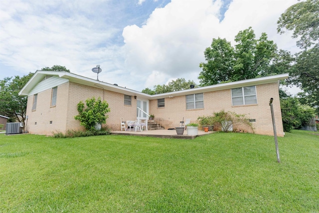 rear view of property featuring a patio, central AC unit, and a yard