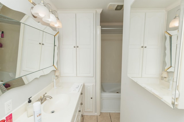 bathroom featuring tile floors, ornamental molding, and vanity with extensive cabinet space