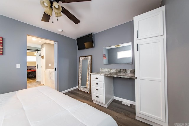 bedroom featuring a barn door, ceiling fan, multiple windows, and dark wood-type flooring