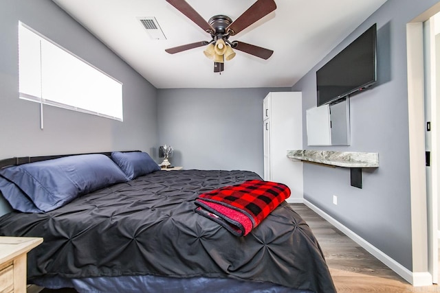 bedroom featuring ceiling fan and hardwood / wood-style flooring