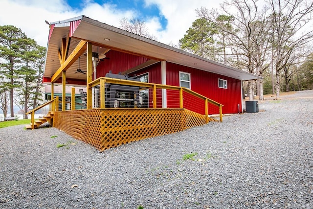 view of side of property featuring a deck and central AC