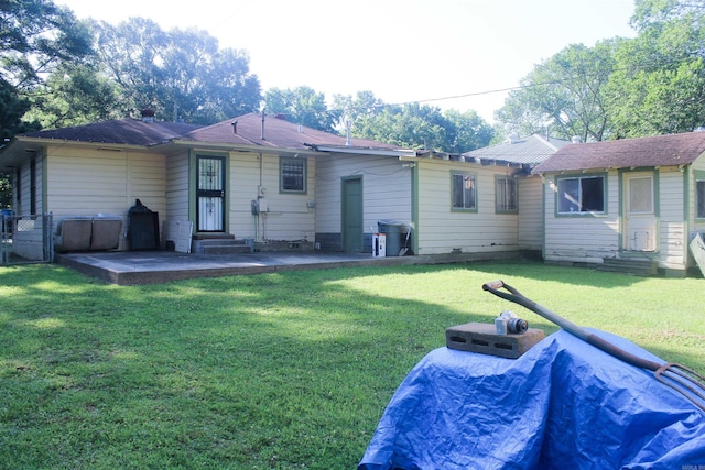 back of property with a lawn