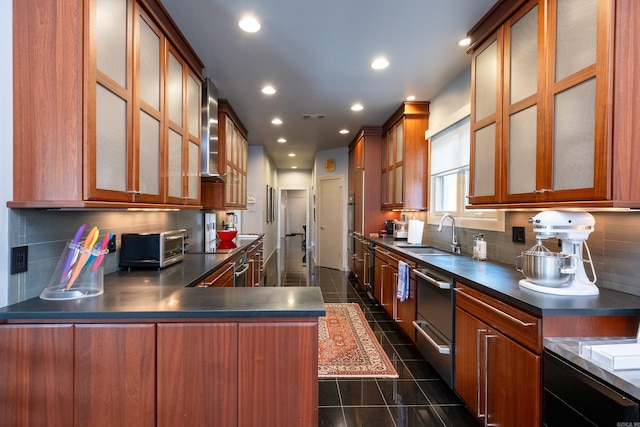 kitchen featuring a warming drawer, dark countertops, visible vents, a sink, and dark tile patterned floors