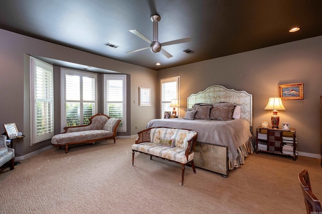 bedroom with light carpet, recessed lighting, visible vents, and baseboards