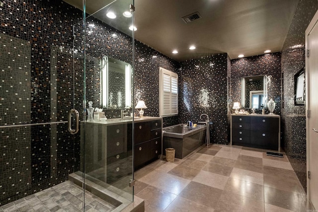 full bath with visible vents, a garden tub, a shower stall, and vanity