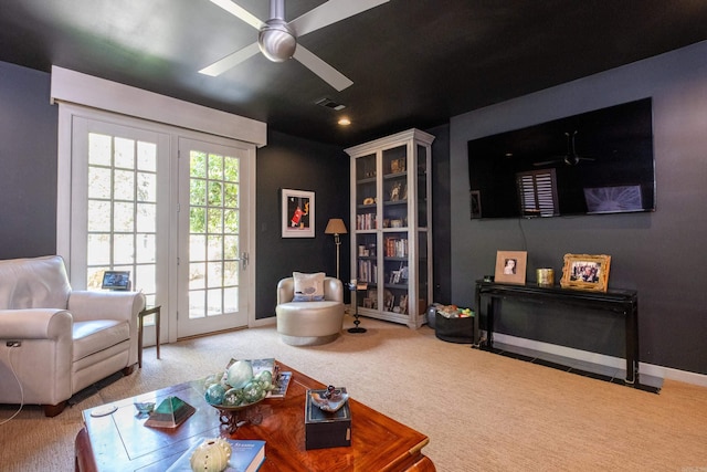 carpeted living area with visible vents, ceiling fan, and baseboards