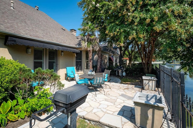 view of patio featuring outdoor dining area and fence