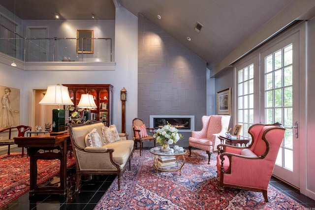 sitting room featuring high vaulted ceiling, a wealth of natural light, visible vents, and a fireplace