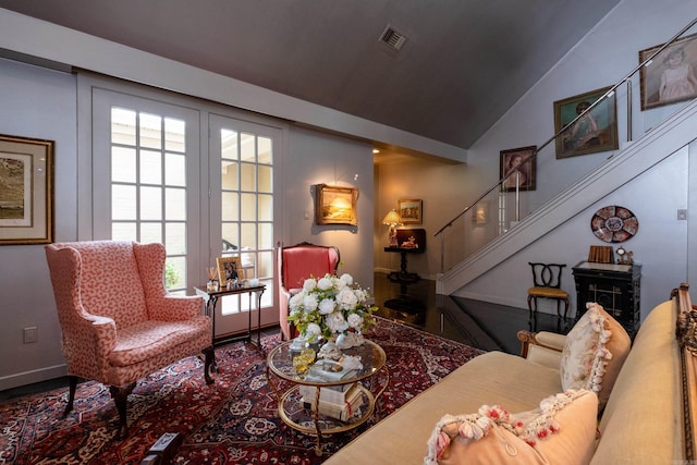 living room with lofted ceiling, visible vents, stairway, and baseboards