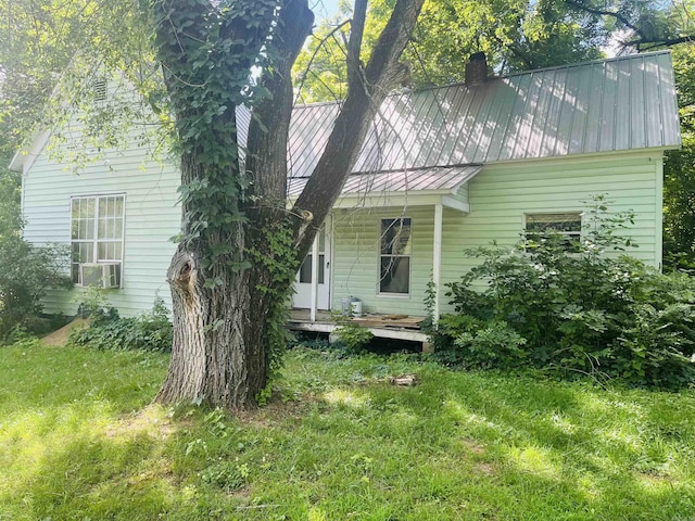 view of front of property with cooling unit and a front yard