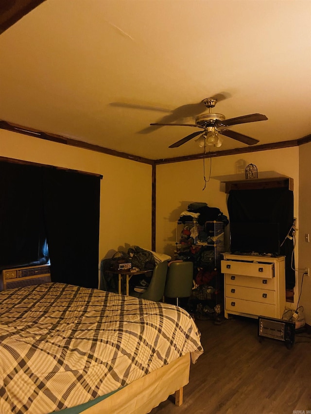 bedroom featuring hardwood / wood-style floors, ceiling fan, and crown molding