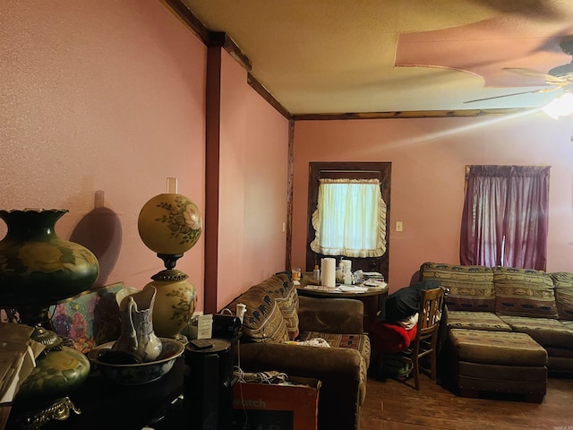 living room with hardwood / wood-style floors, ceiling fan, and crown molding