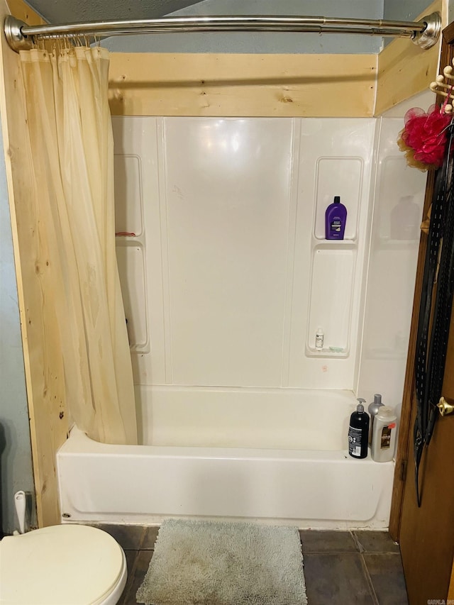 bathroom with shower / bath combo and toilet