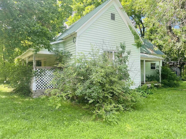 view of side of home featuring a yard