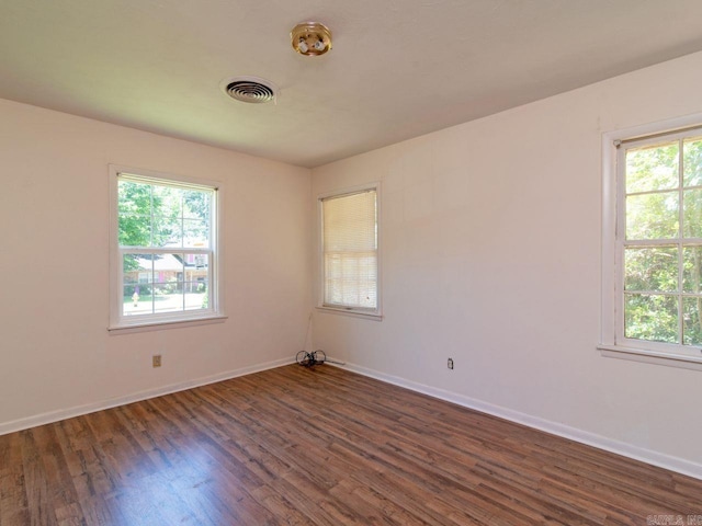 spare room with dark wood-type flooring