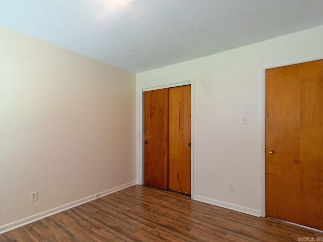 empty room featuring dark wood-type flooring