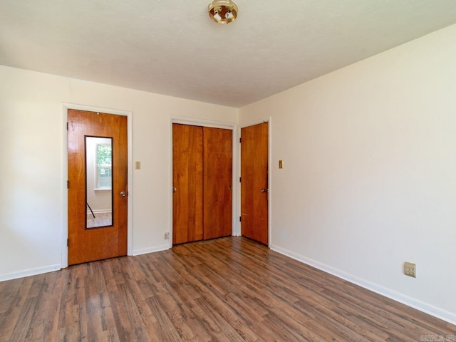 unfurnished room with dark hardwood / wood-style flooring