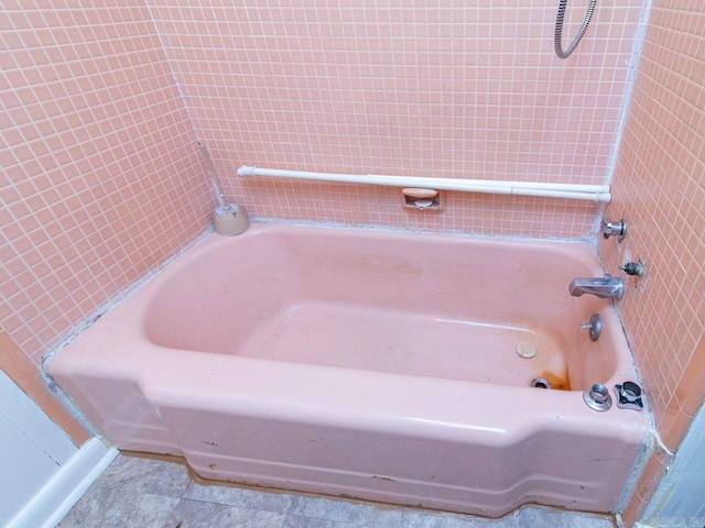 bathroom with a tub to relax in