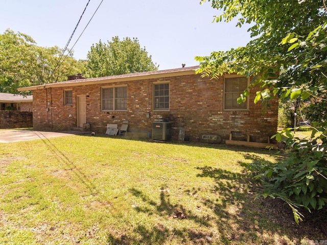 back of house with a lawn and cooling unit