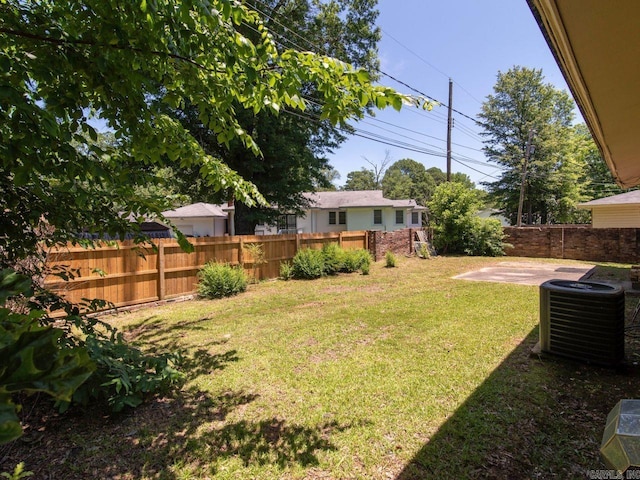 view of yard with a patio and central AC unit