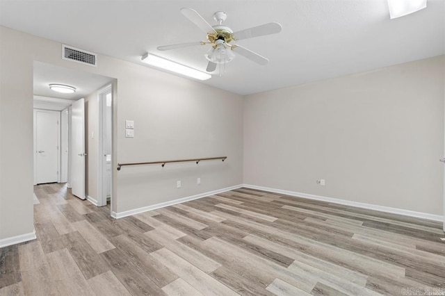 empty room featuring ceiling fan and light hardwood / wood-style flooring