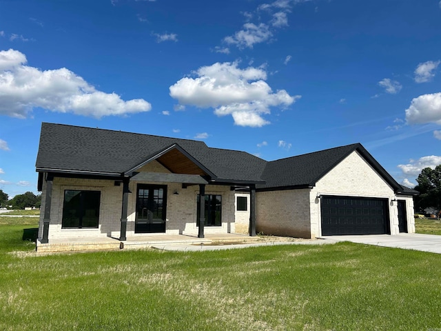 view of front of home with a garage and a front lawn