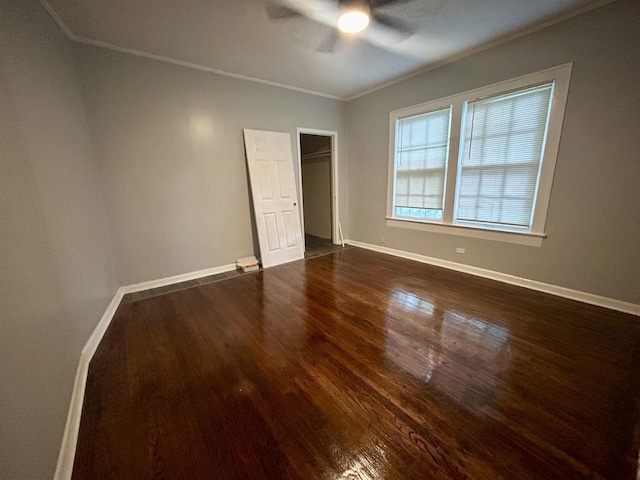 unfurnished bedroom with crown molding, ceiling fan, and dark hardwood / wood-style flooring