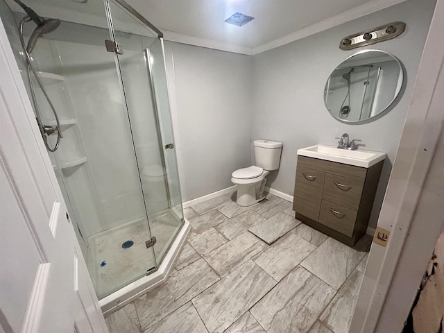 bathroom with vanity, ornamental molding, toilet, and walk in shower