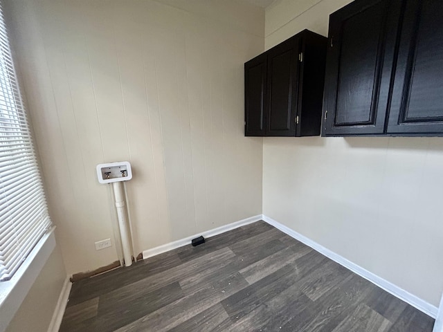 clothes washing area with washer hookup, dark hardwood / wood-style floors, and cabinets