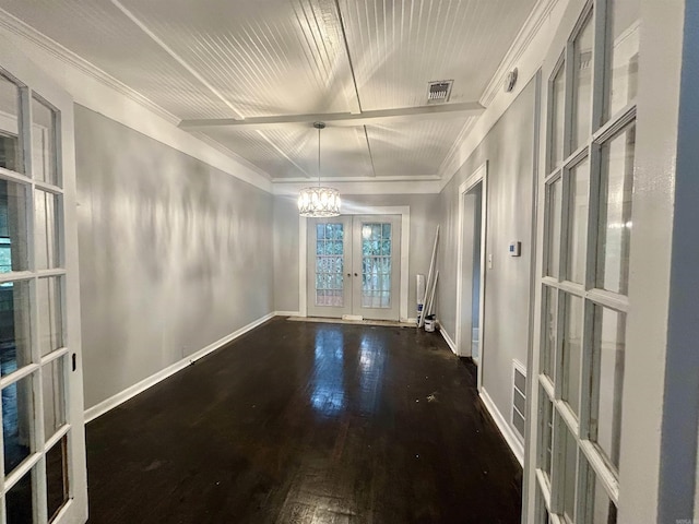 unfurnished room with french doors, dark wood-type flooring, and a notable chandelier