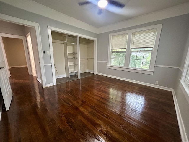 unfurnished bedroom with a closet, dark hardwood / wood-style floors, and ceiling fan