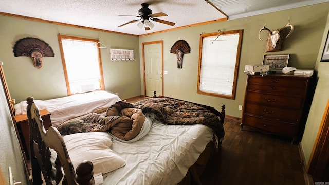 bedroom featuring wood-type flooring, ceiling fan, a textured ceiling, and multiple windows