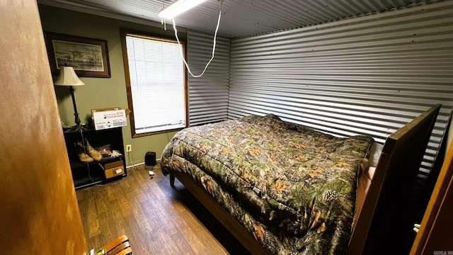 bedroom with dark hardwood / wood-style flooring