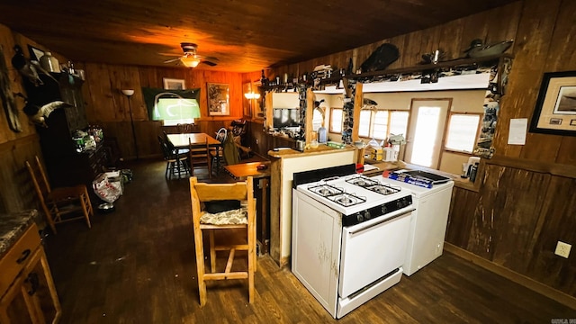 kitchen with white gas stove, ceiling fan, wood ceiling, wood-type flooring, and wooden walls