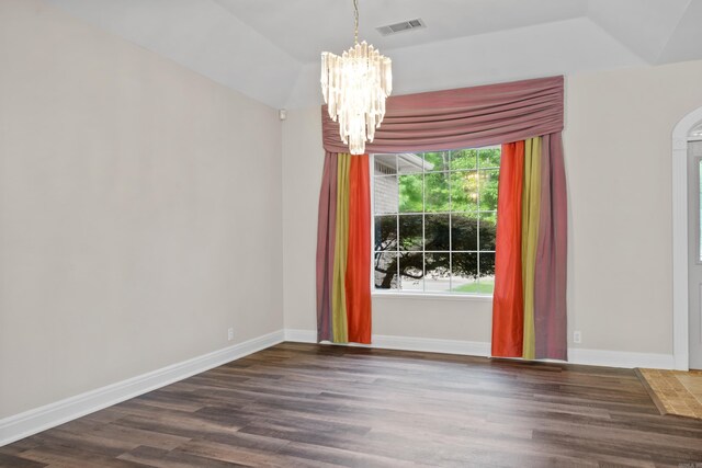 spare room featuring a chandelier and dark hardwood / wood-style floors