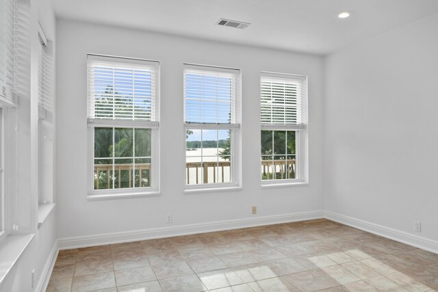 spare room featuring light tile floors