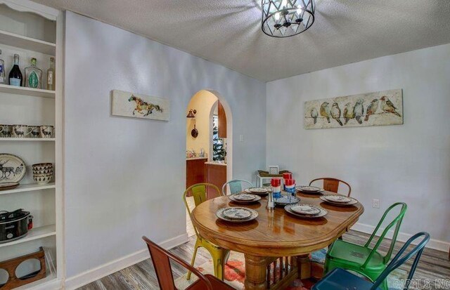 kitchen with light stone countertops, lofted ceiling with beams, stainless steel appliances, and sink