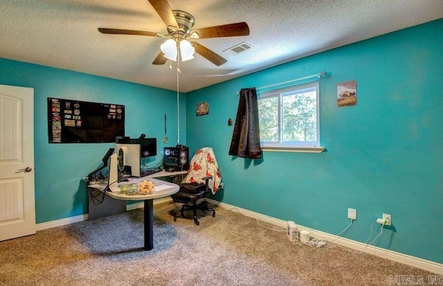 office area with ceiling fan, carpet, and a textured ceiling