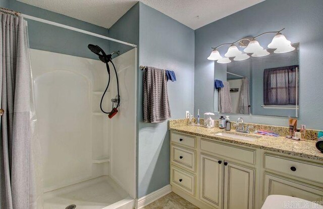 laundry room featuring separate washer and dryer, cabinets, a textured ceiling, and a barn door