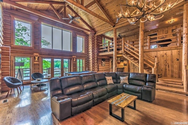 living room with beam ceiling, log walls, high vaulted ceiling, wood ceiling, and hardwood / wood-style flooring
