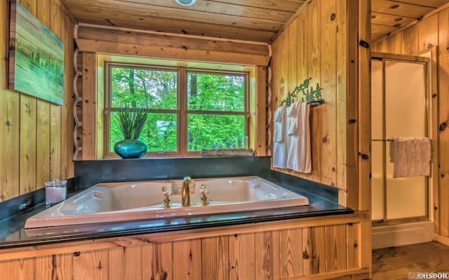 bathroom featuring hardwood / wood-style flooring, wood walls, wooden ceiling, and shower with separate bathtub