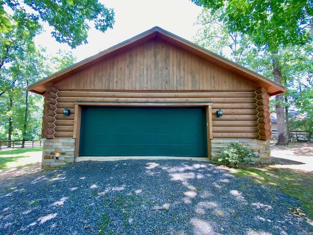 exterior space featuring a garage and an outbuilding