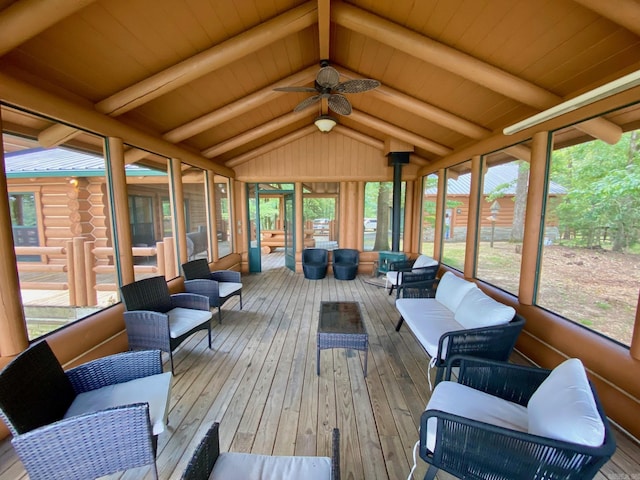 sunroom / solarium with ceiling fan and lofted ceiling with beams