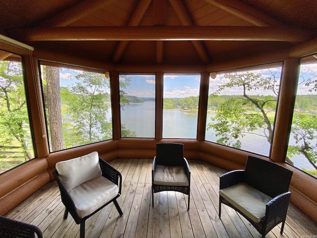 sunroom with wooden ceiling, a water view, and lofted ceiling with beams
