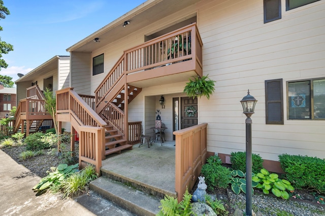 view of exterior entry with a patio area