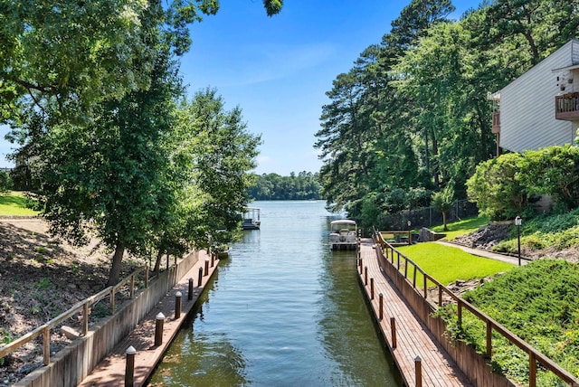 view of dock featuring a yard and a water view